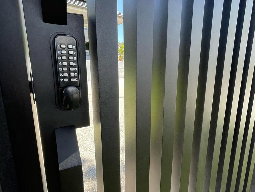 A Close up Of a Gate with A Keypad on It — Optimum Aluminium Fabrication in Barrack Heights, NSW