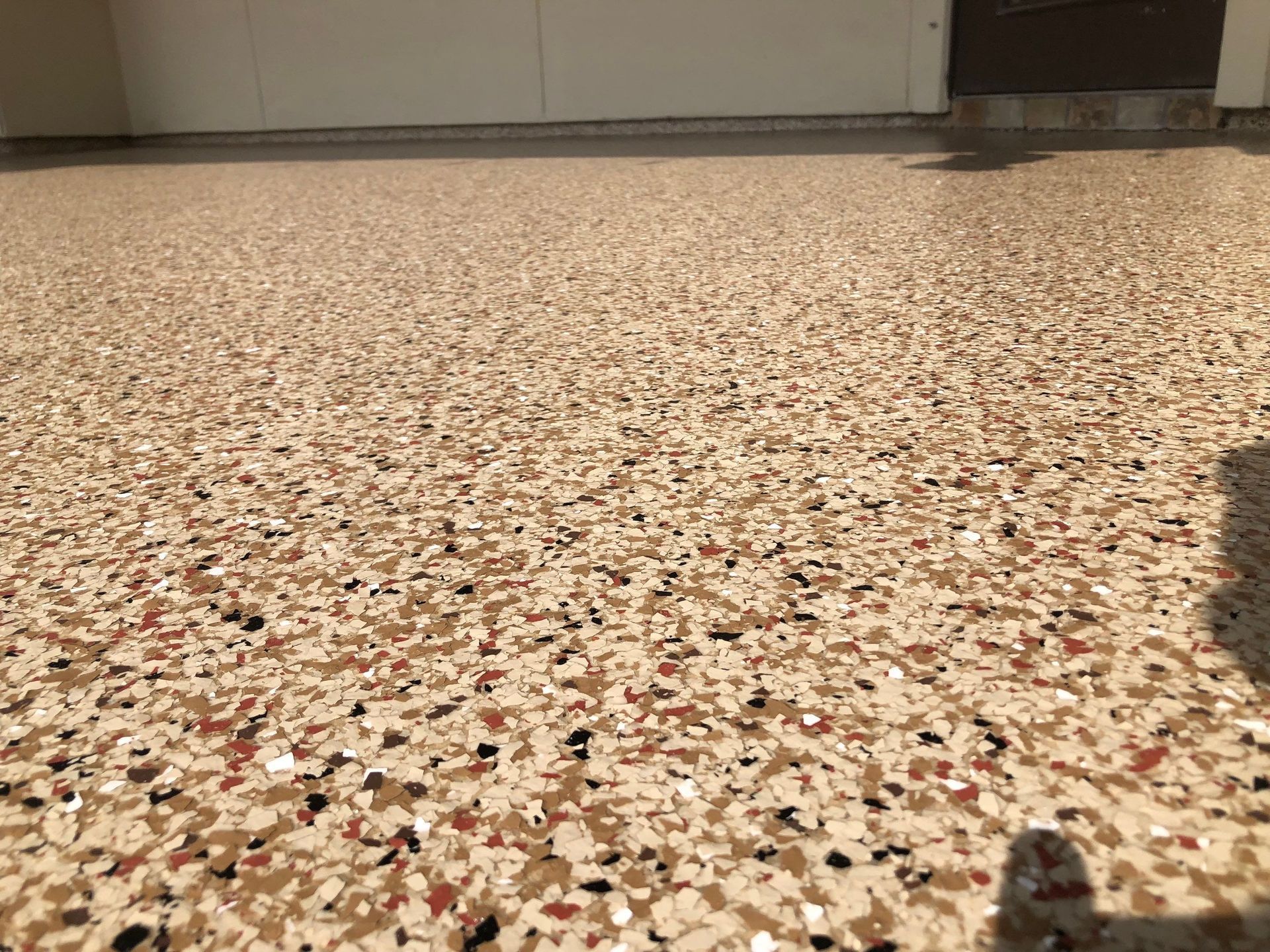 Tan and speckled epoxy garage floor.