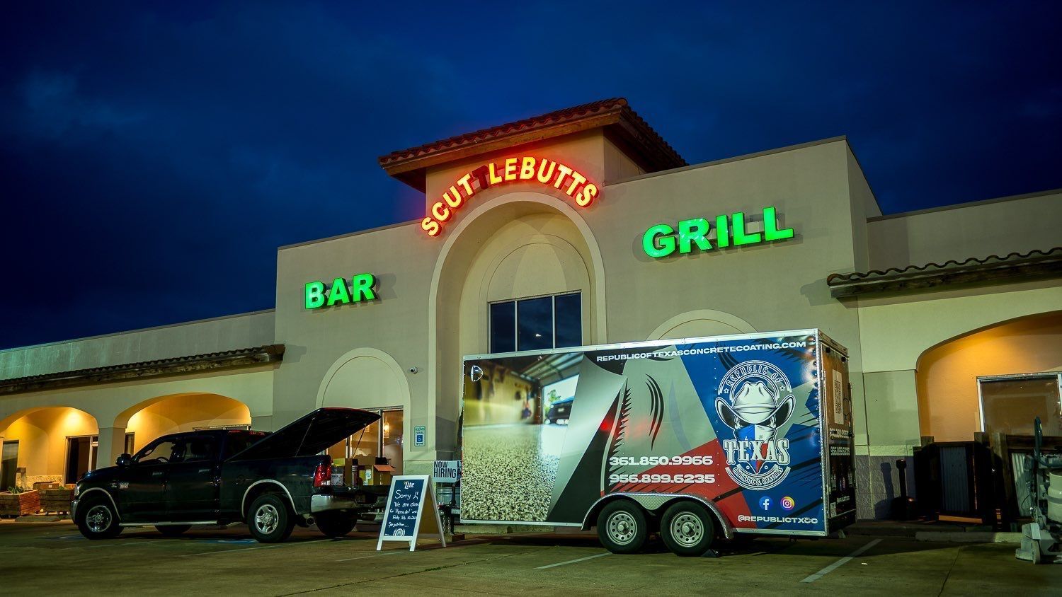 Scout Lebutt's Grill, bar sign, truck parked with food trailer, night setting.