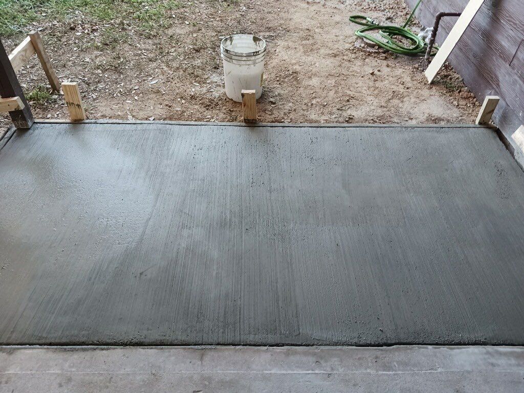 Freshly poured concrete slab with wooden forms.