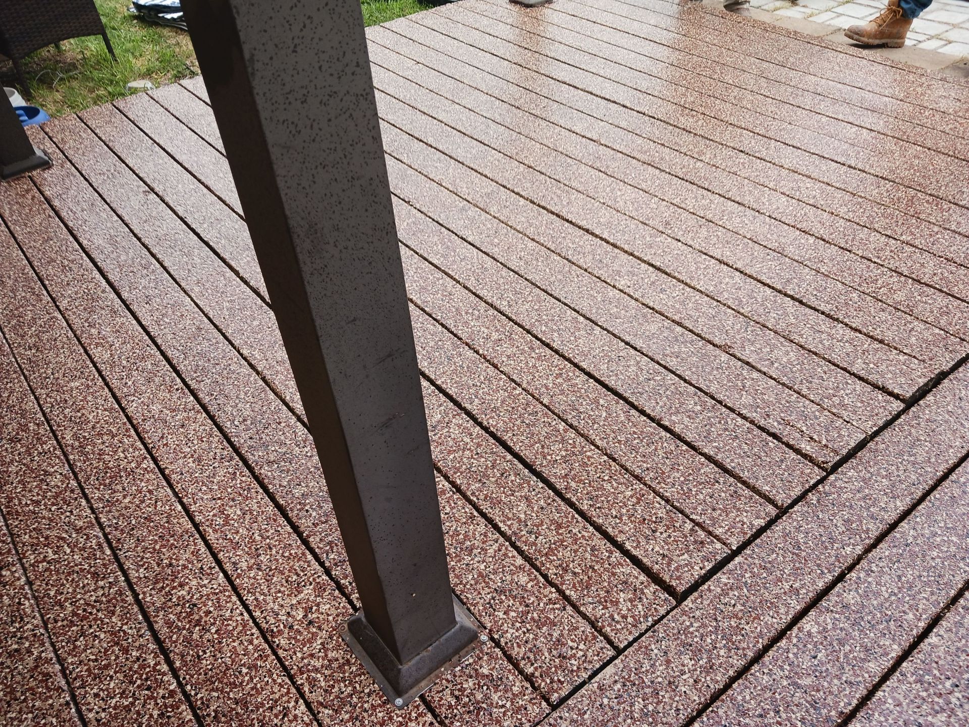 Brown composite deck with a dark post.