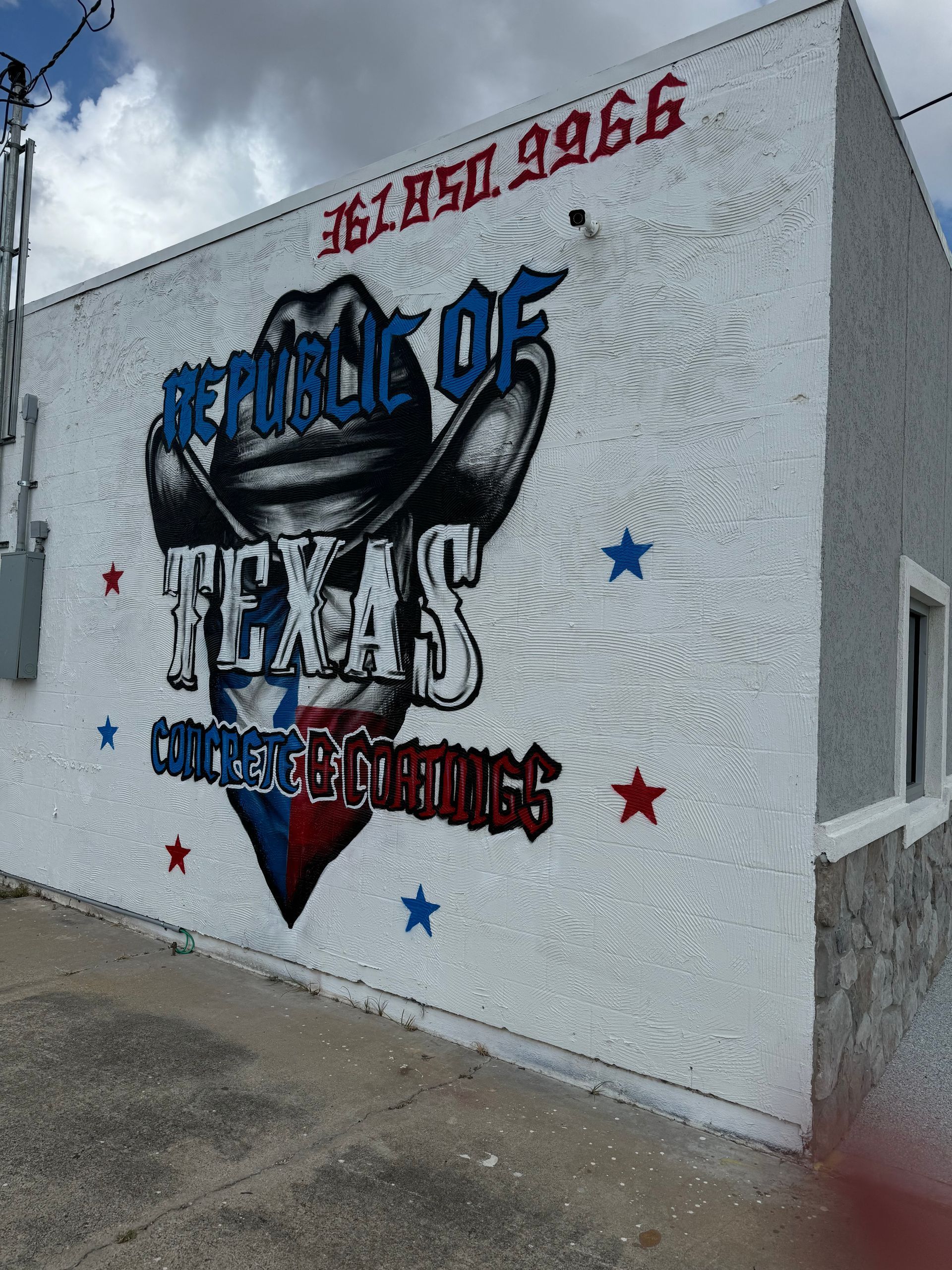 Republic of Texas Concrete Coatings building with mural and phone number.