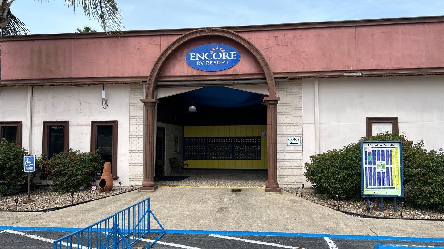 Building entrance with blue accents, a sign that reads 