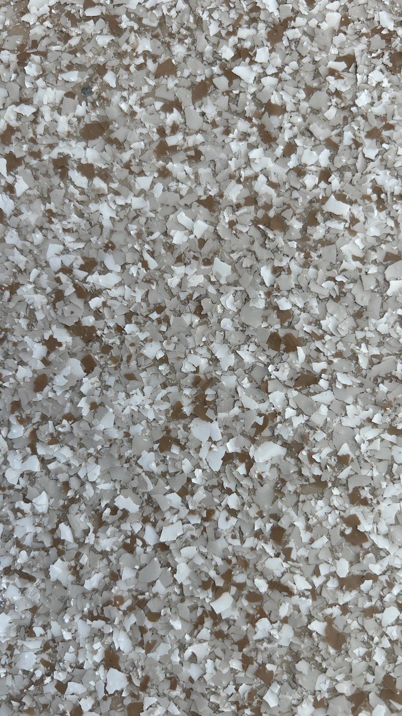 Gray and white speckled floor with hints of brown.