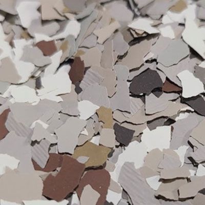 Speckled, multicolored flooring chips in beige, white, gray, and brown.