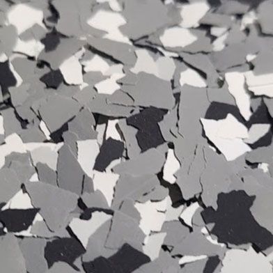 Close-up of gray, white, and black decorative floor flakes.