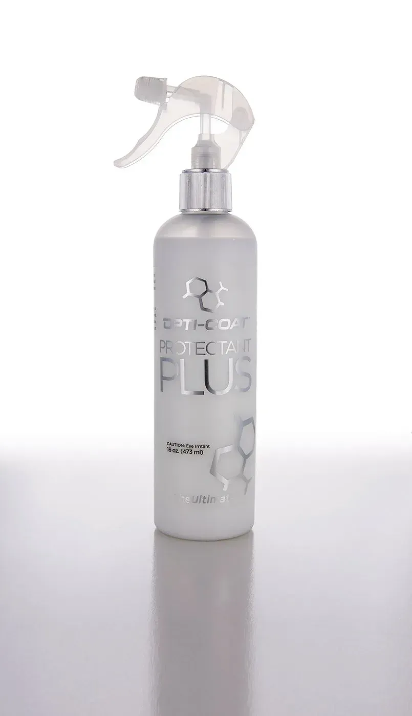 A white spray bottle is sitting on a white surface.