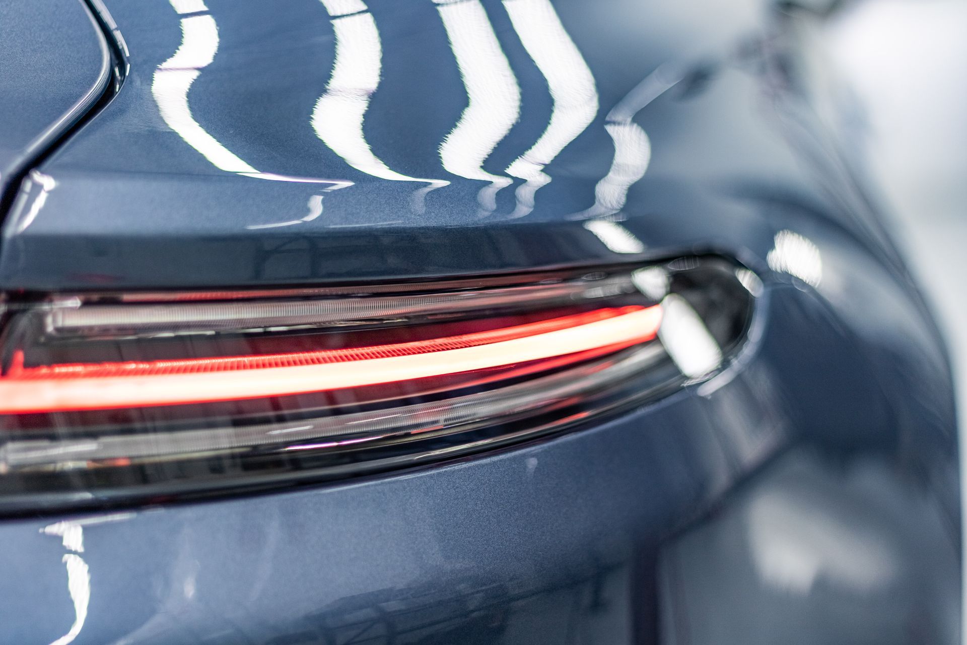 A close up of a car 's tail light with smoke coming out of it.