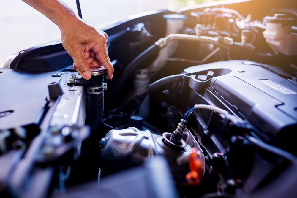 A Person Is Opening The Radiator Cap Of A Car — S&A Automotive Repairs Pty Ltd In Yarrawonga, VIC