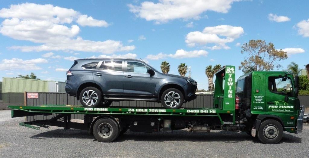 A Car Is Sitting On Top Of A Green Tow Truck — S&A Automotive Repairs Pty Ltd In Yarrawonga, VIC
