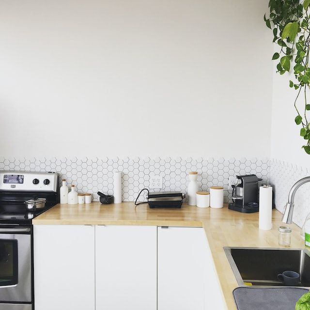 A kitchen counter with a coffee pod holder and a kettle.
