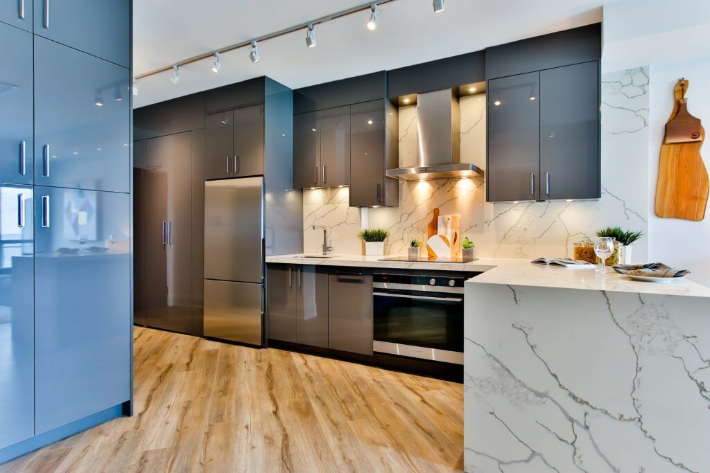 A kitchen with stainless steel appliances and a large island.