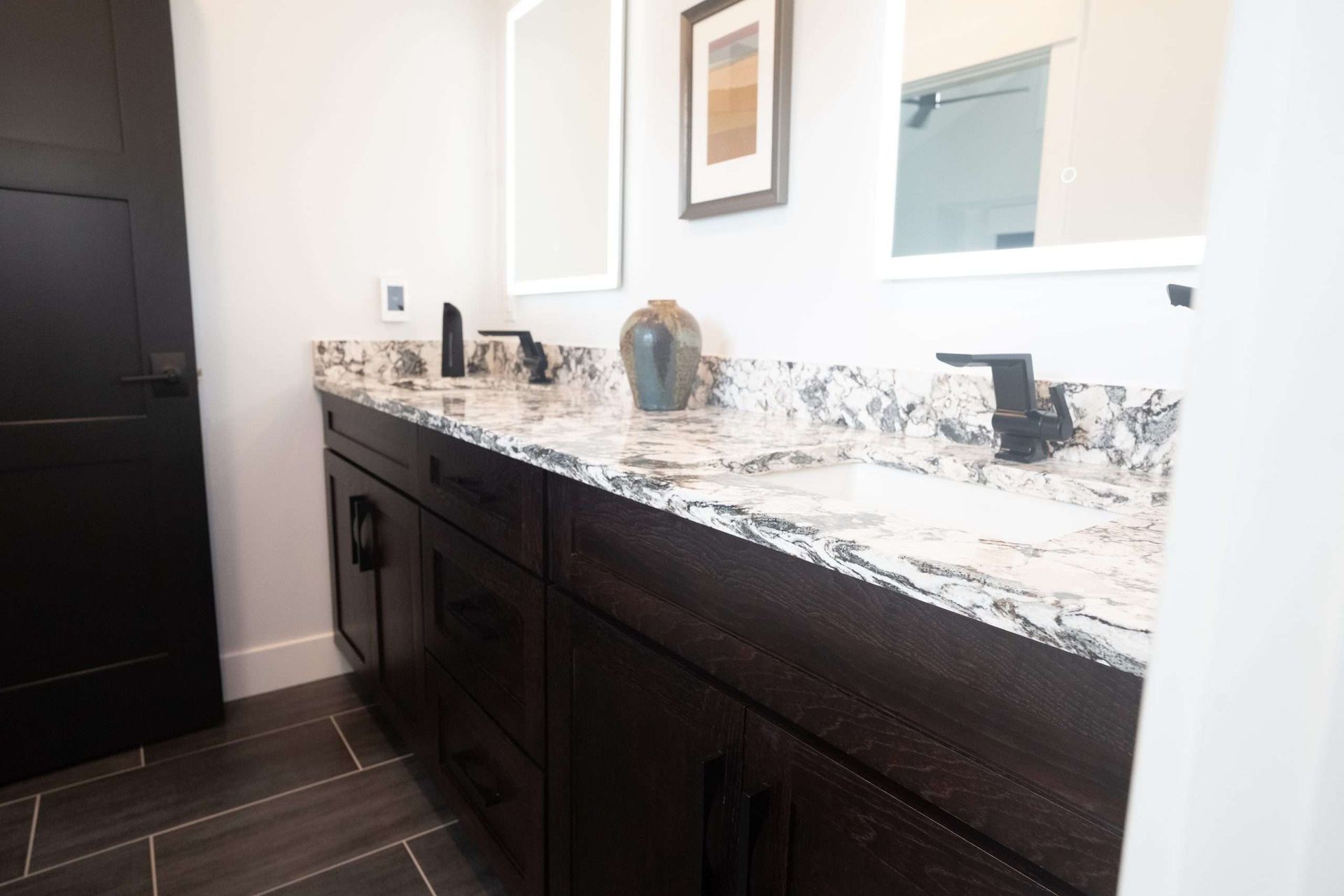A bathroom with two sinks and two mirrors.