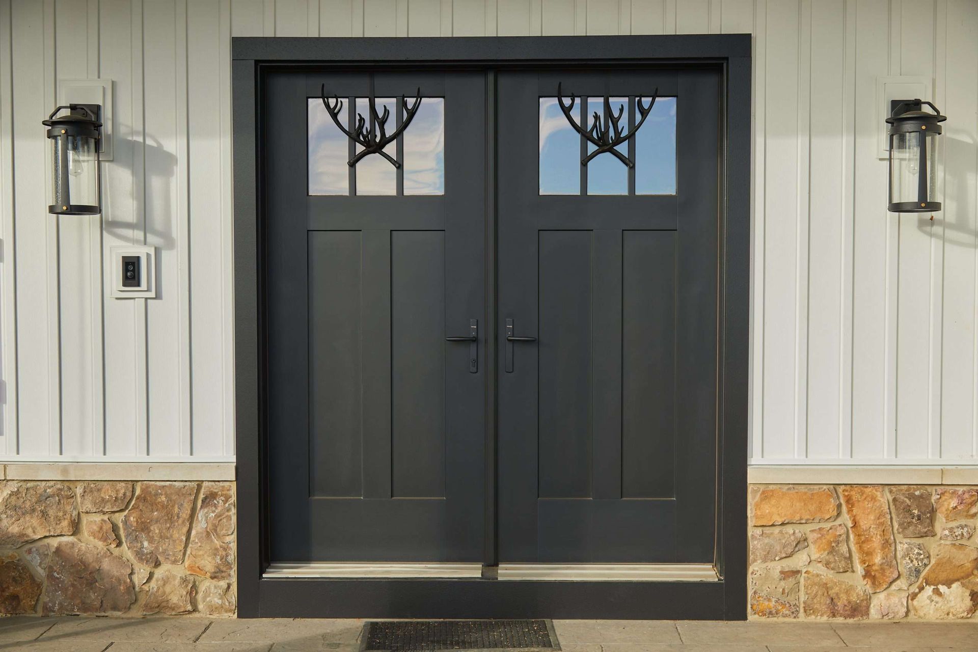 A black double door with a tree design on it