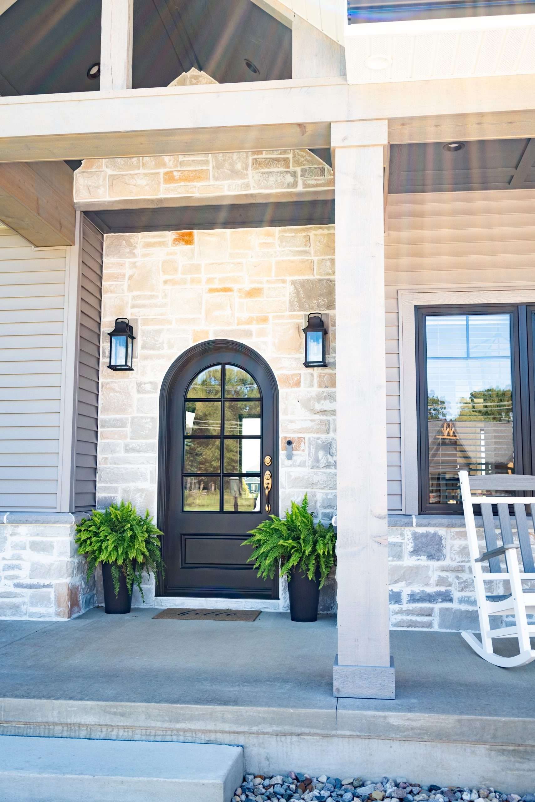 There is a rocking chair on the porch of a house.