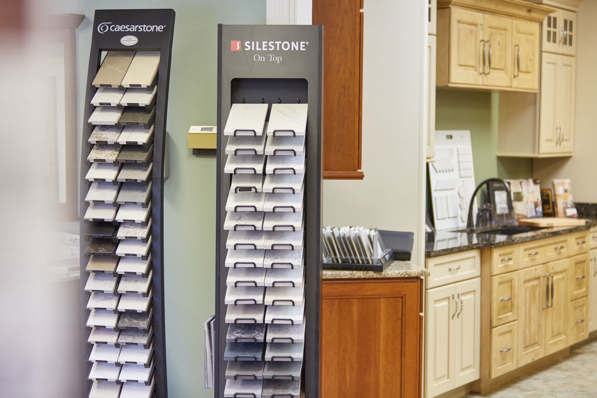 A kitchen with a lot of cabinets and a display of tiles.