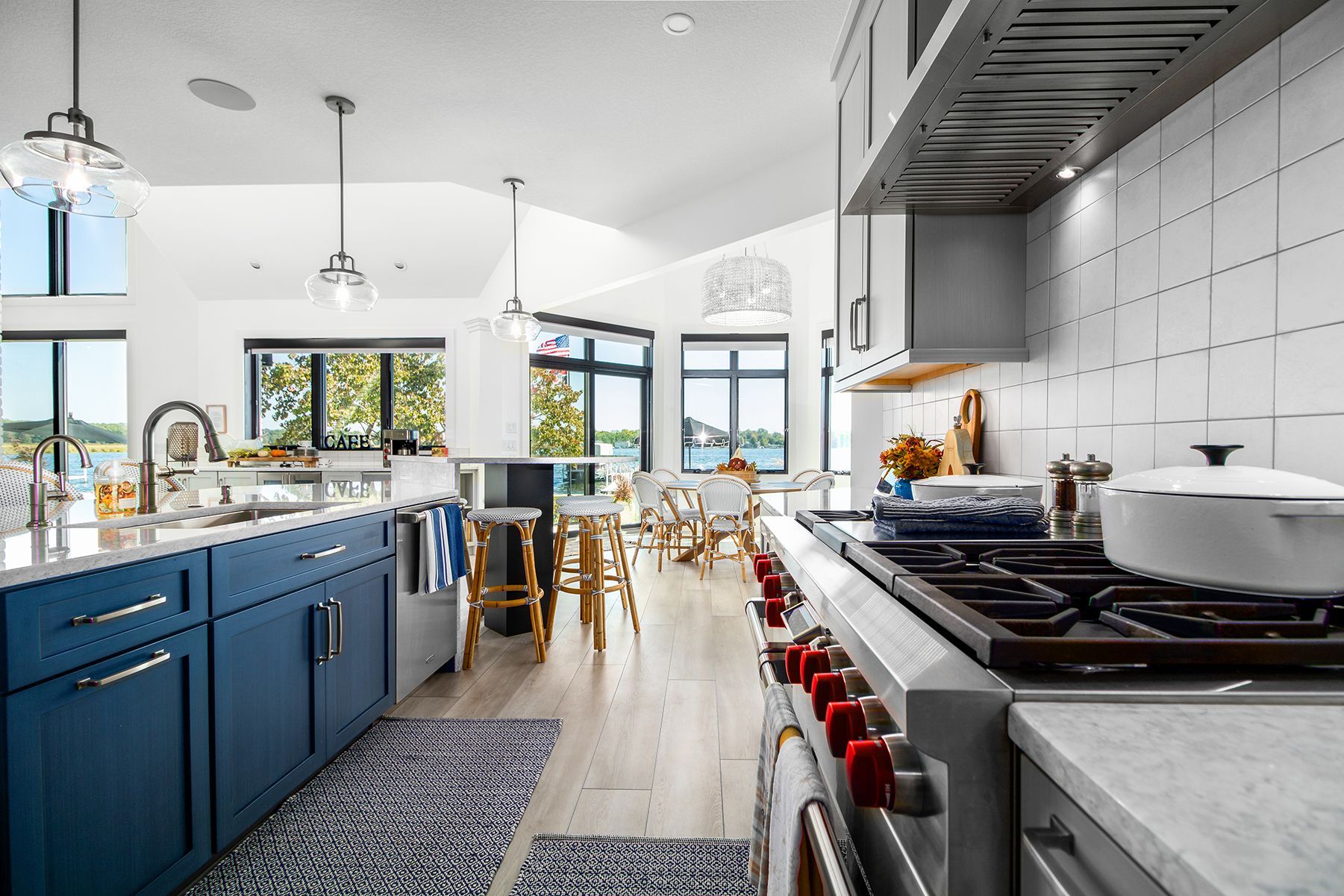 A kitchen with blue cabinets and a stove top oven.