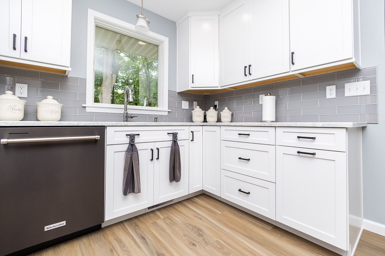 A kitchen with black cabinets and stainless steel appliances