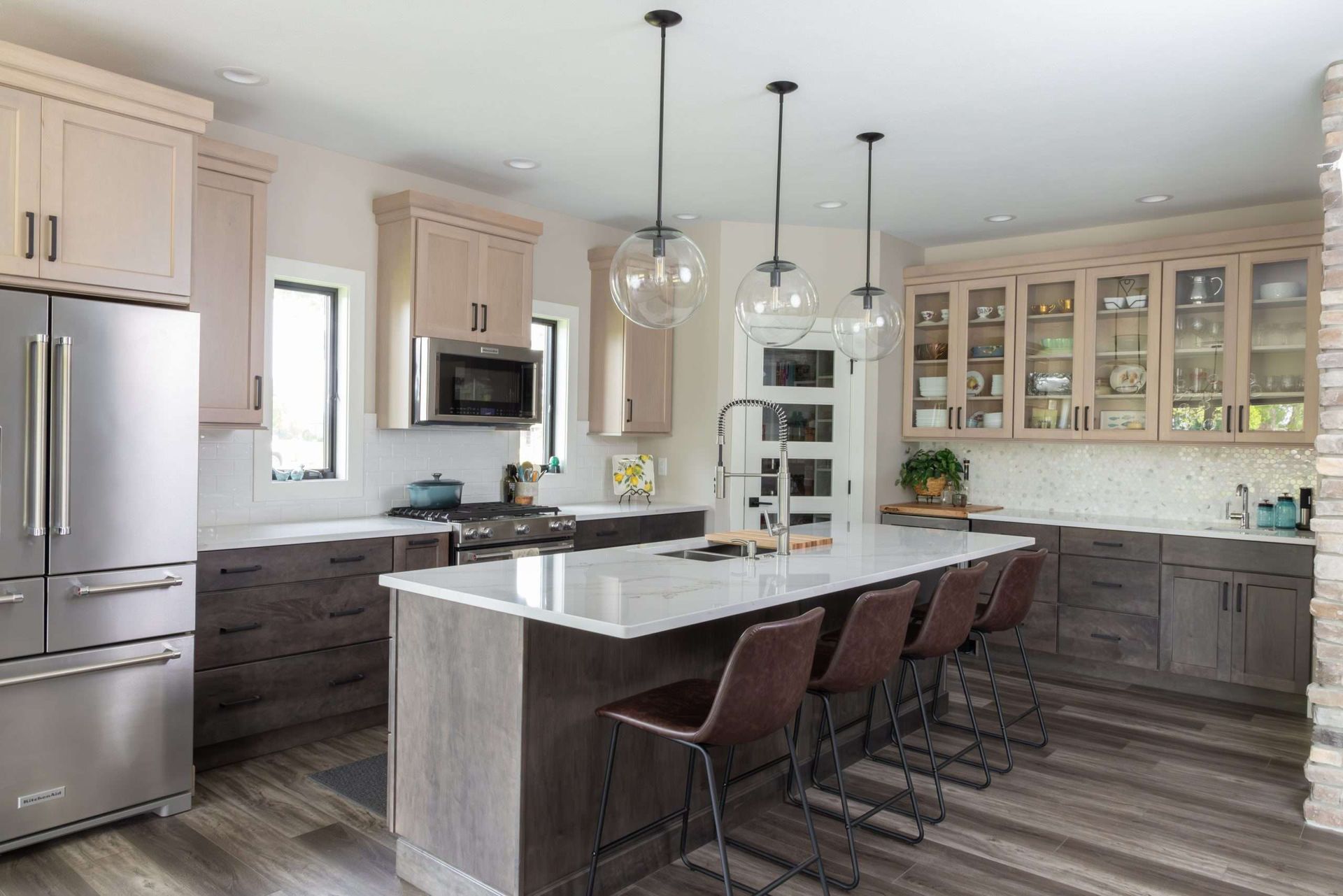 A kitchen with stainless steel appliances , wooden cabinets , and a large island.