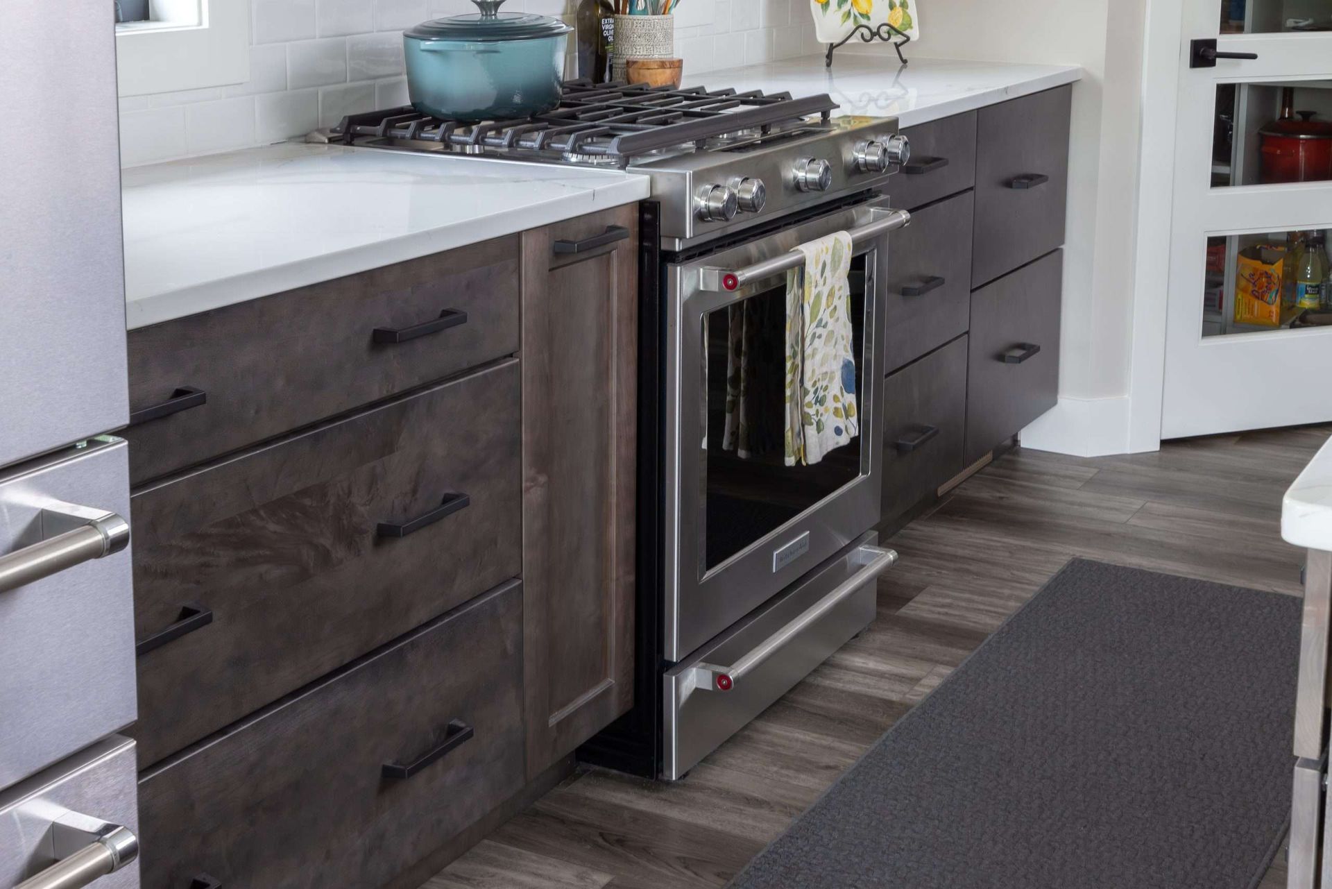 A kitchen with stainless steel appliances and wooden cabinets.