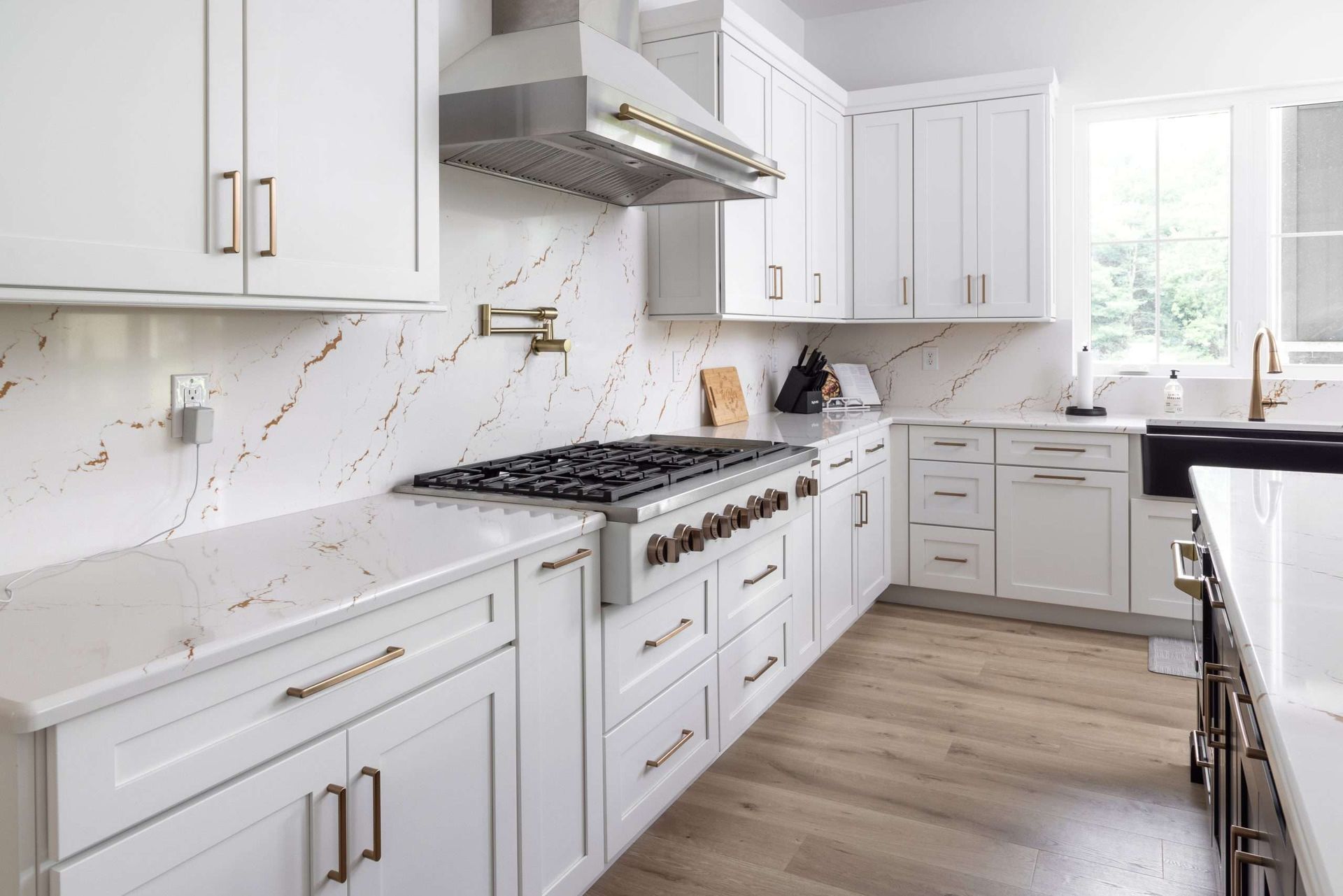 A kitchen with white cabinets and stainless steel appliances.