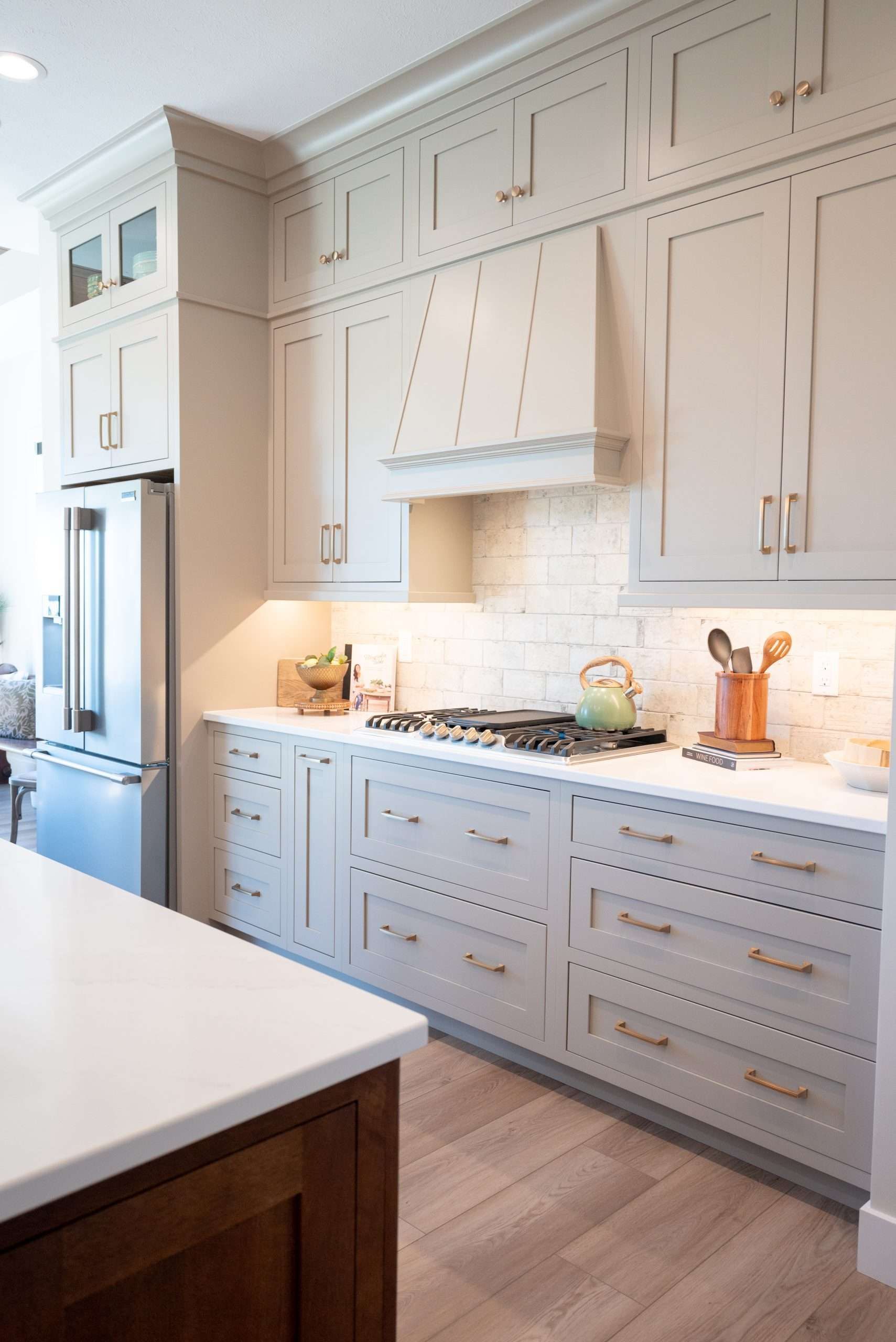 A kitchen with blue cabinets and a stove top oven.