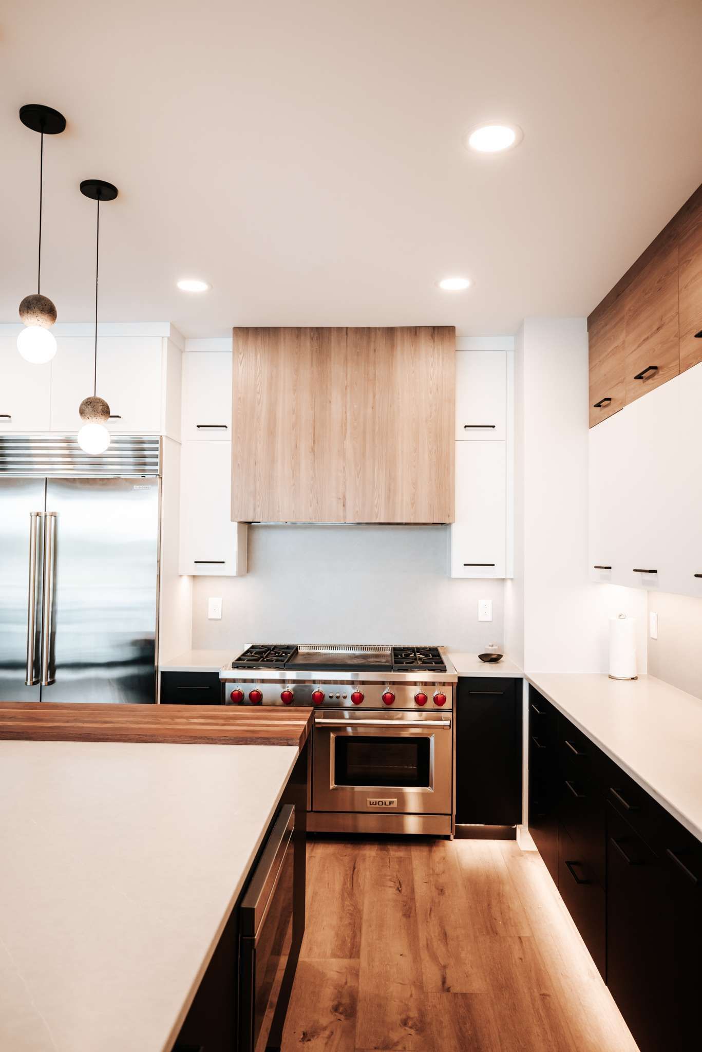 A kitchen with stainless steel appliances and wooden cabinets.