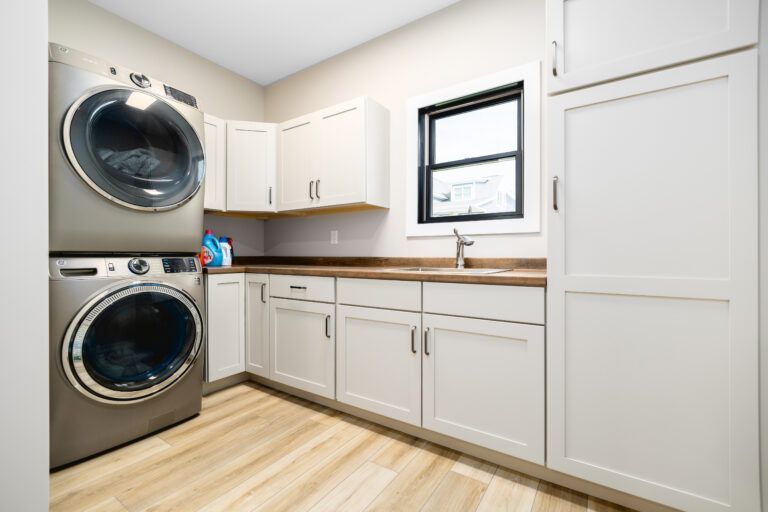 A laundry room with a washer and dryer stacked on top of each other.