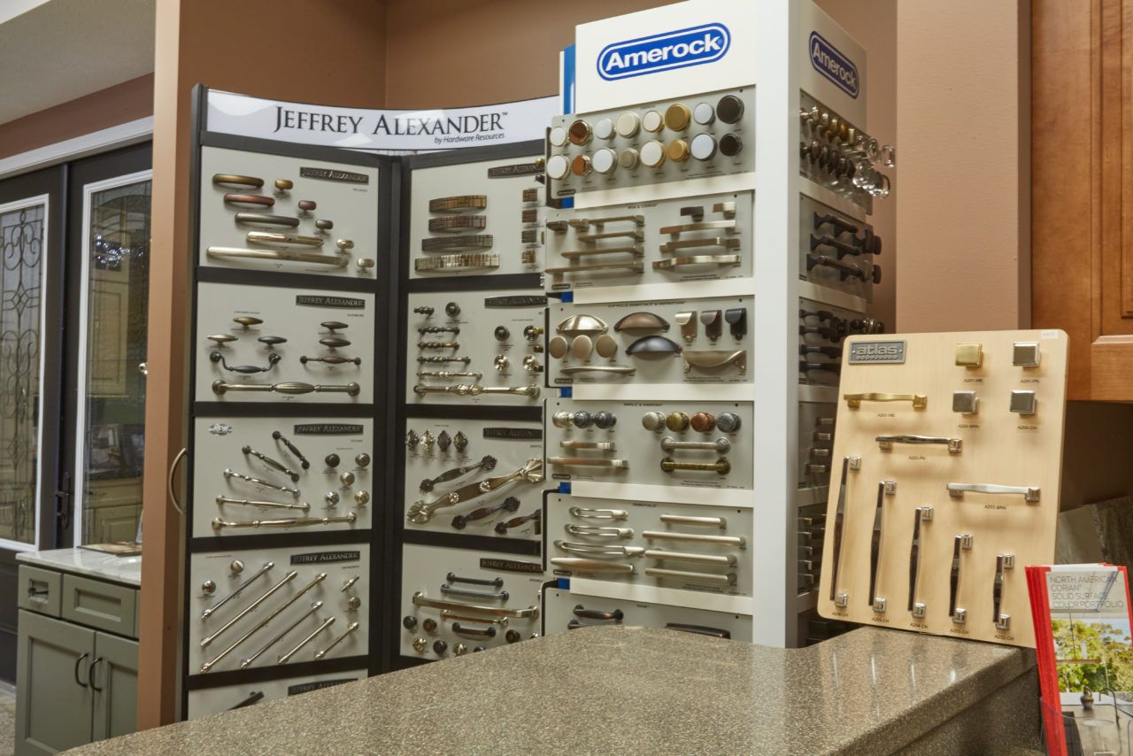 A counter in a store with a display of handles and knobs