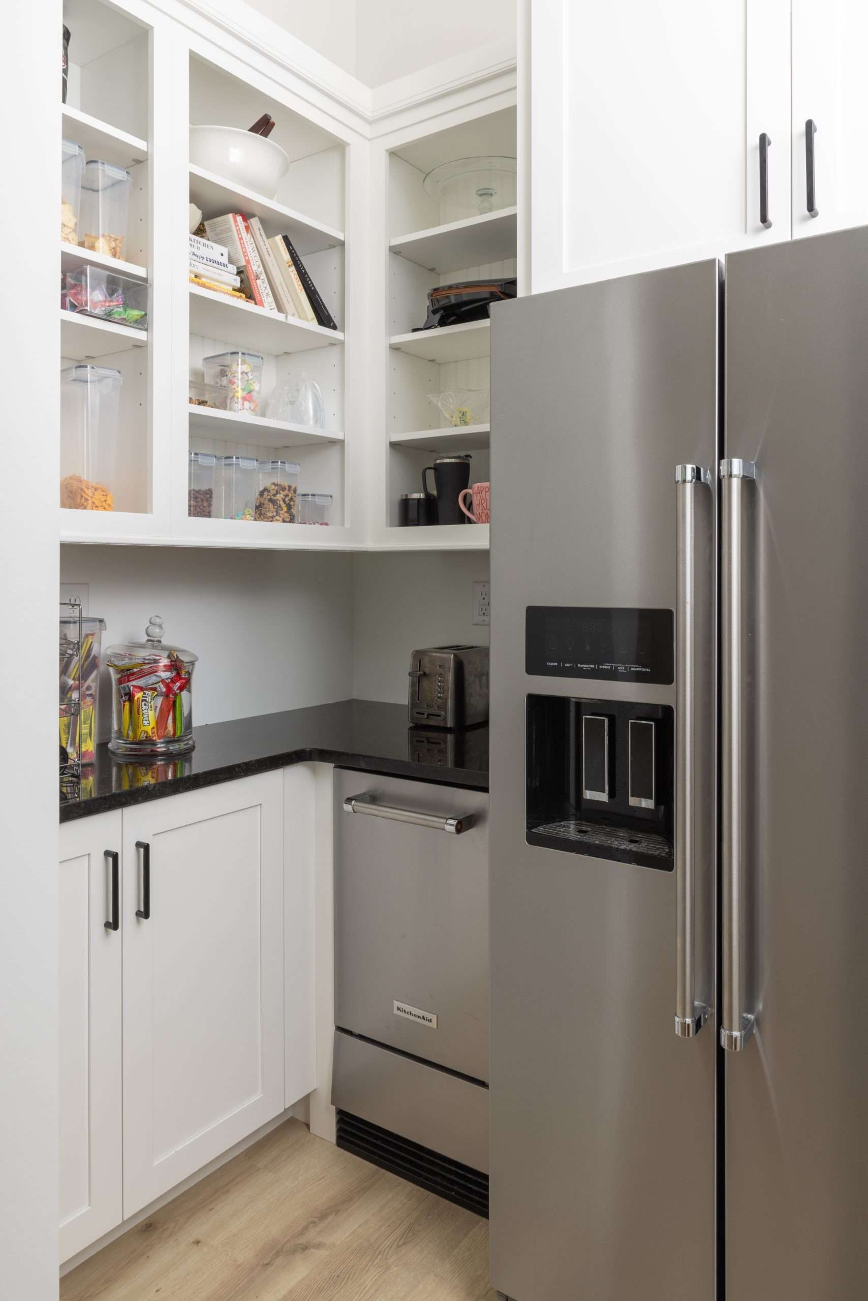 A kitchen with a stainless steel refrigerator and a dishwasher.