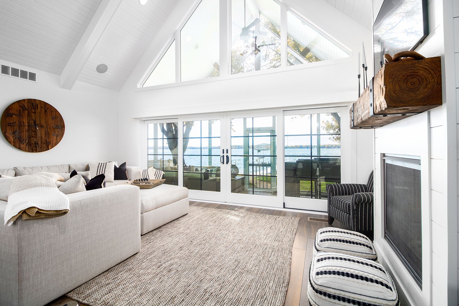 A living room with a lot of windows and a fireplace.