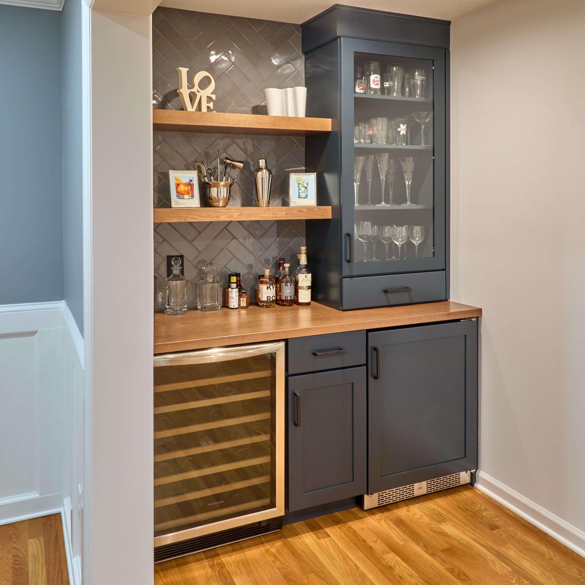 Modern kitchen with white cabinets, quartz countertops, and stainless steel appliances.