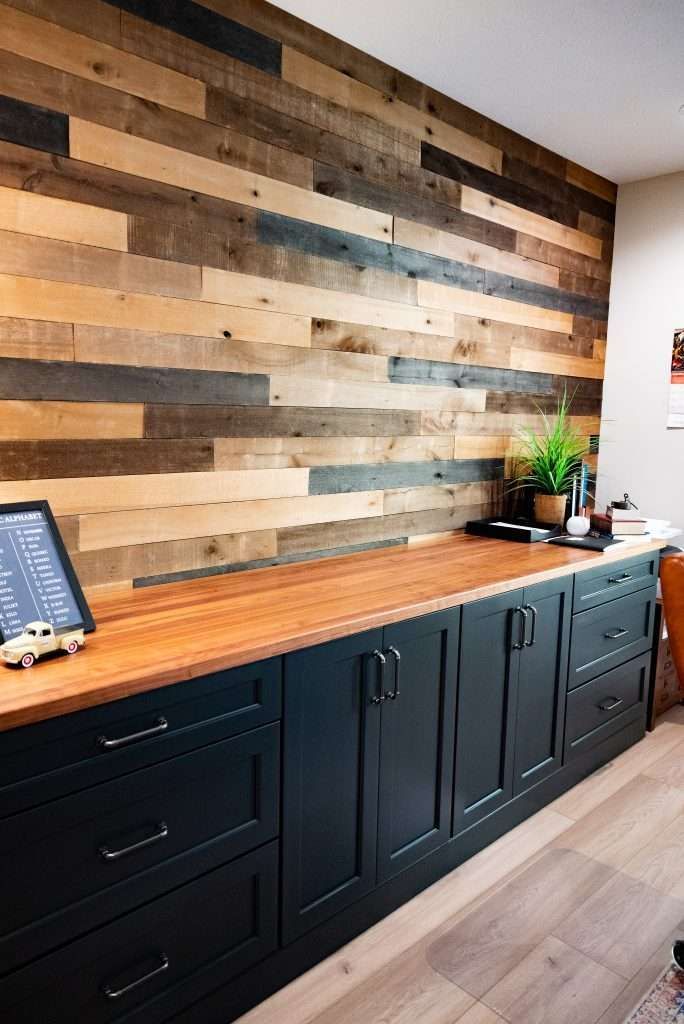 A kitchen with a wooden wall and a wooden counter top.