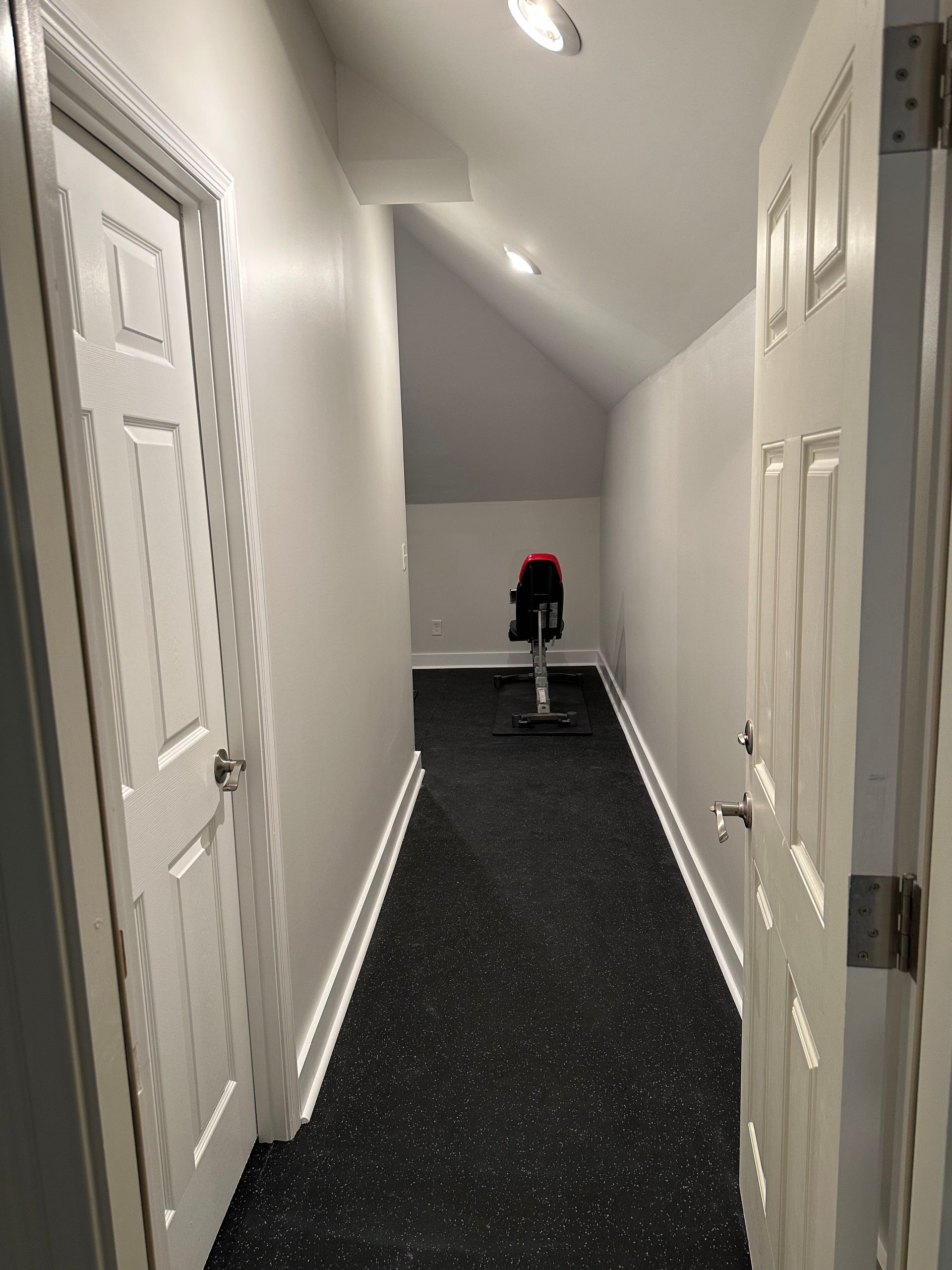 Wooden attic under construction with exposed beams, insulation, and ductwork.