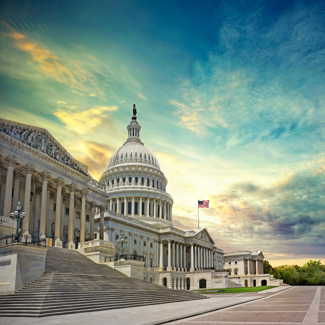 The capitol building in washington d.c. at sunset with a flag flying in the sky.