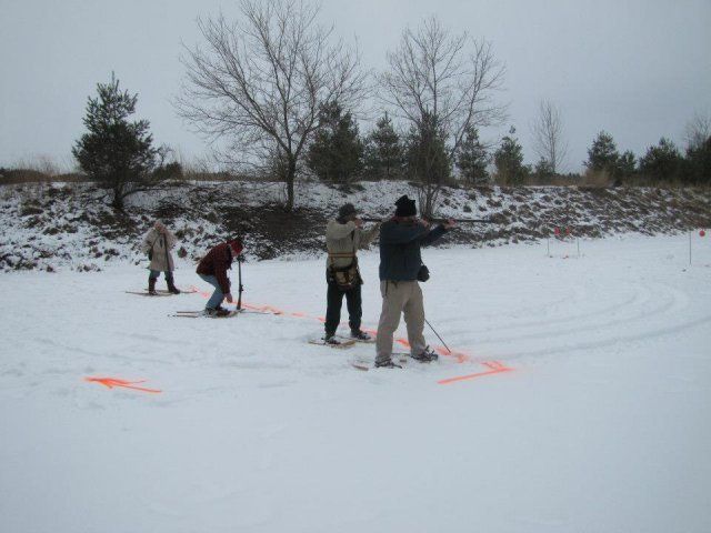 people at firing range in winter