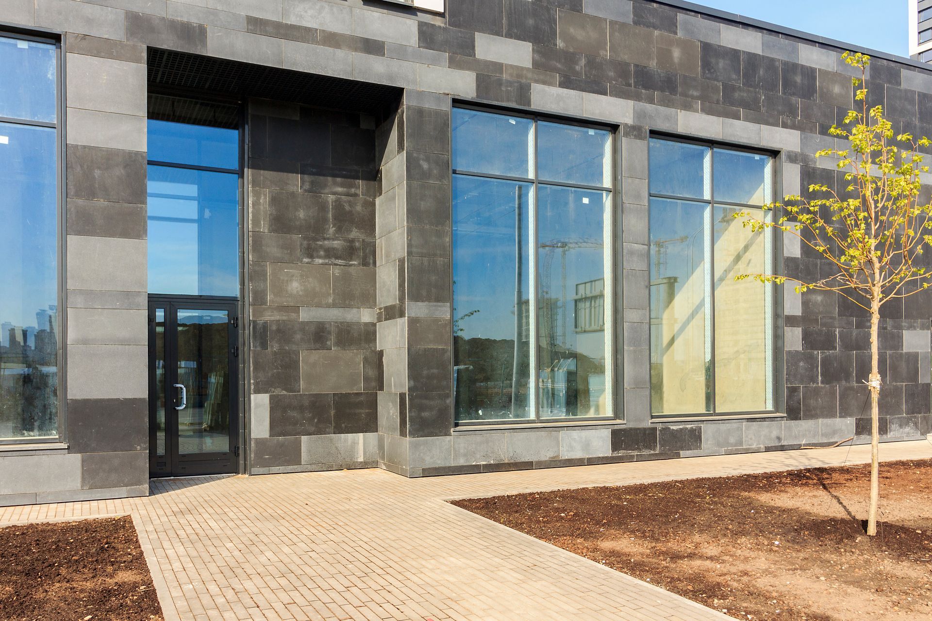 A large building with a lot of windows and a walkway leading to it.