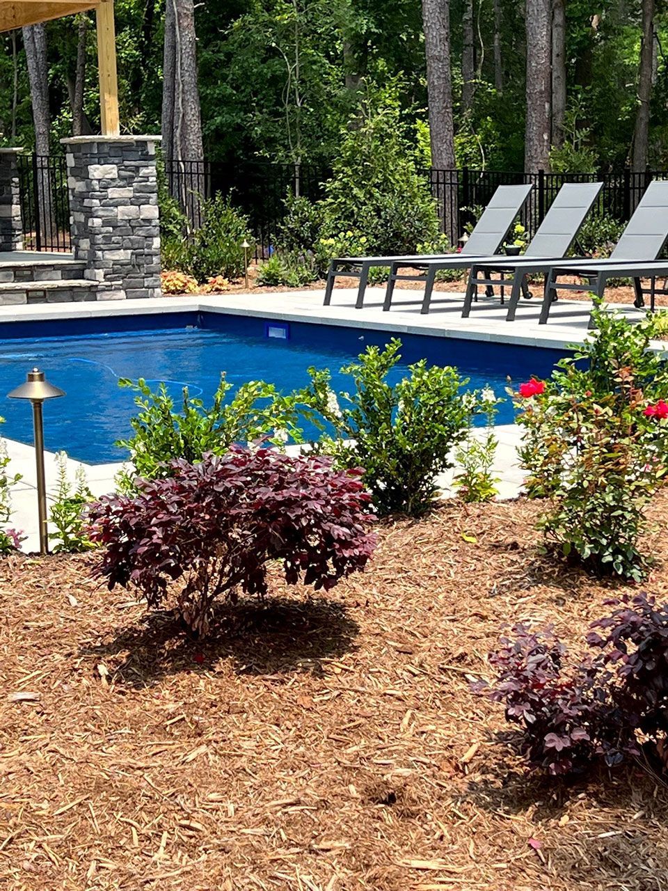 Landscape contractor work near backyard inground pool from Brookscapes LLC