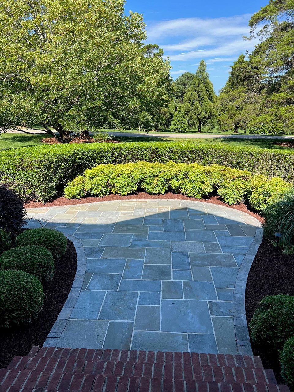 Landscape contract service installing bushes from Brookscapes LLC