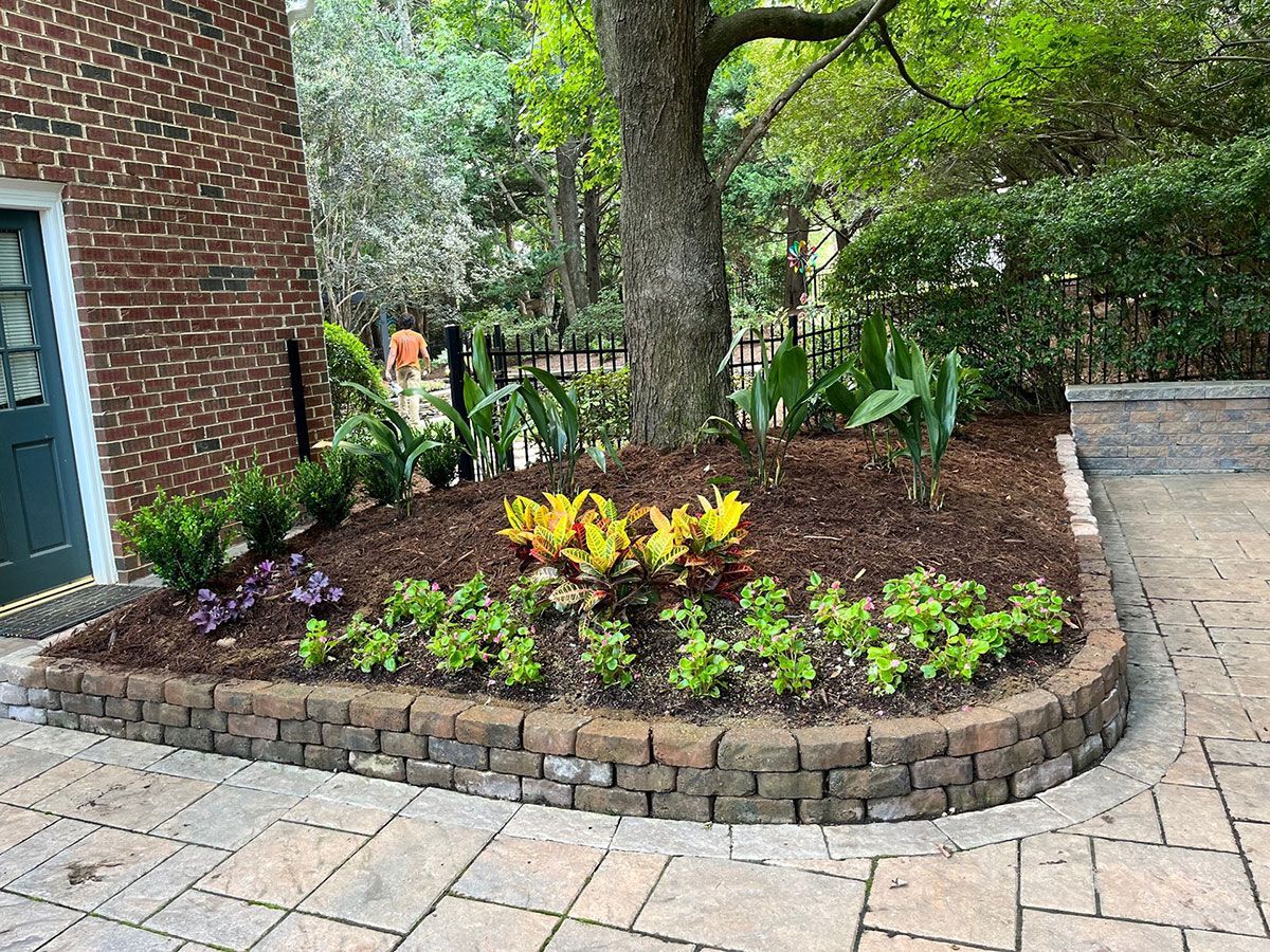 Flower bed installation in a retaining wall from Brookscapes LLC serving Raleigh, Apex and Wake Forest NC