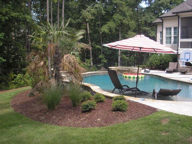 Landscape Services in a residential backyard near a pool from Brookscapes LLC serving Raleigh, Apex and Wake Forest NC