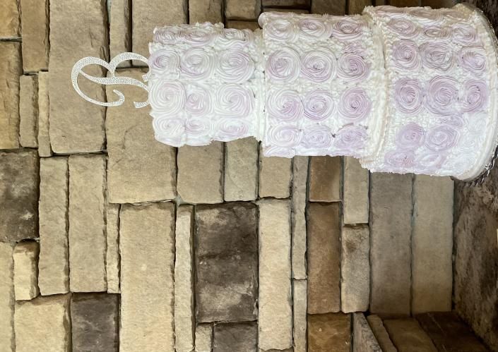 three tier wedding cake with rosettes