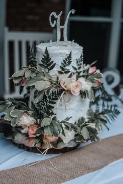 wedding cake with greenery and roses