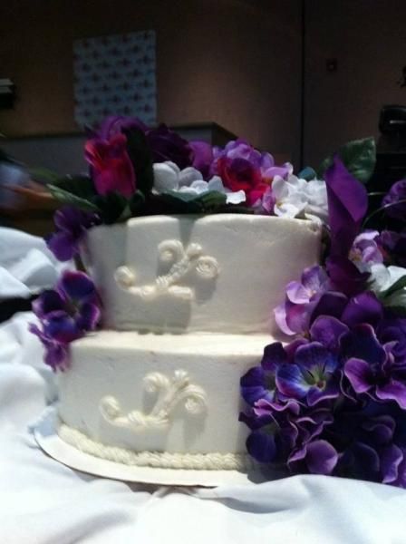 wedding cake with purple flowers