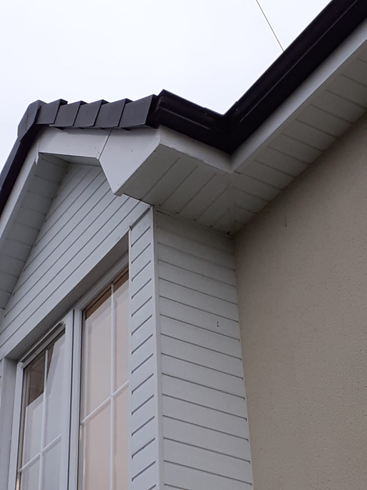 A white house with a window and a roof