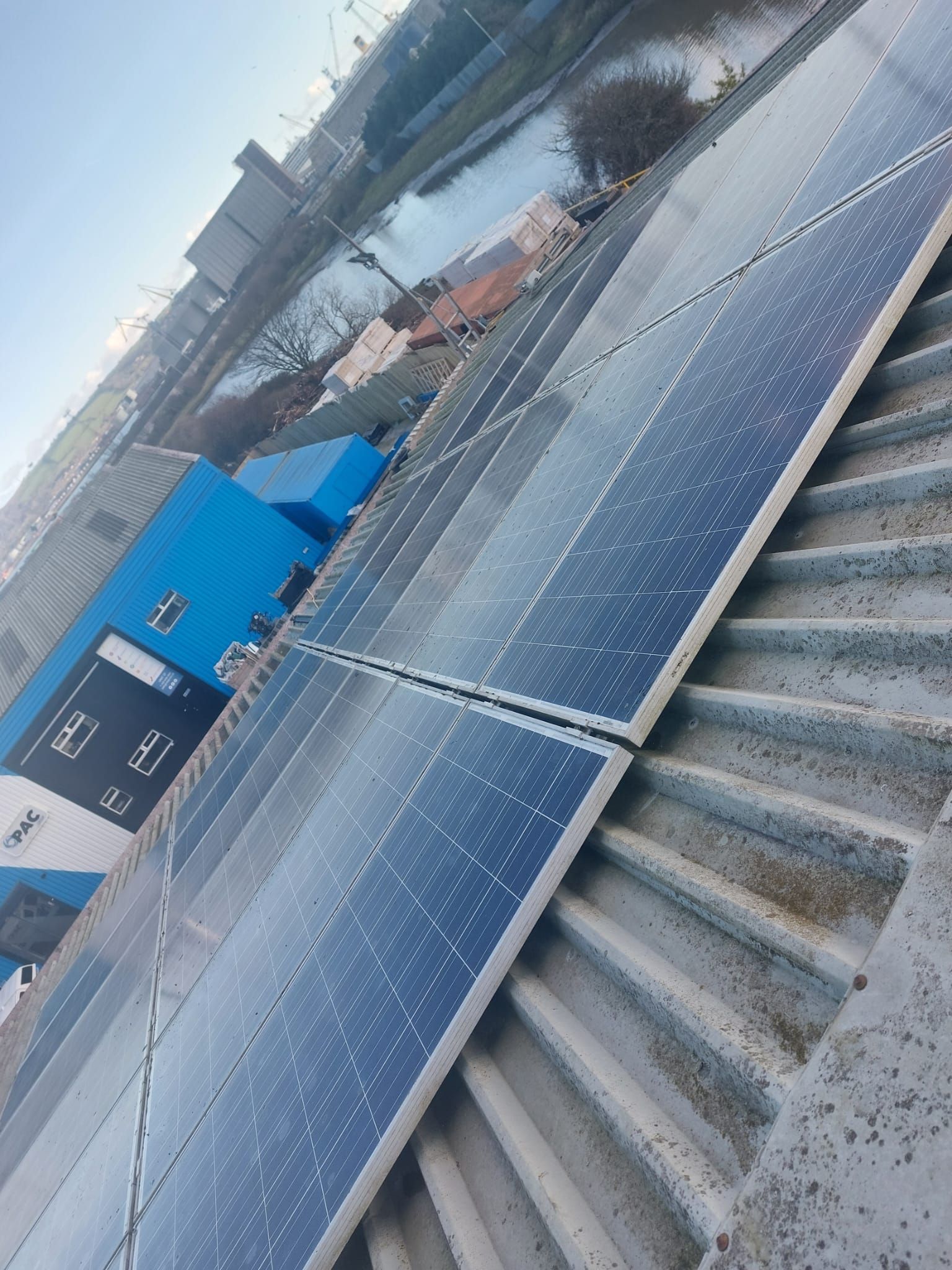 A row of solar panels on the roof of a building