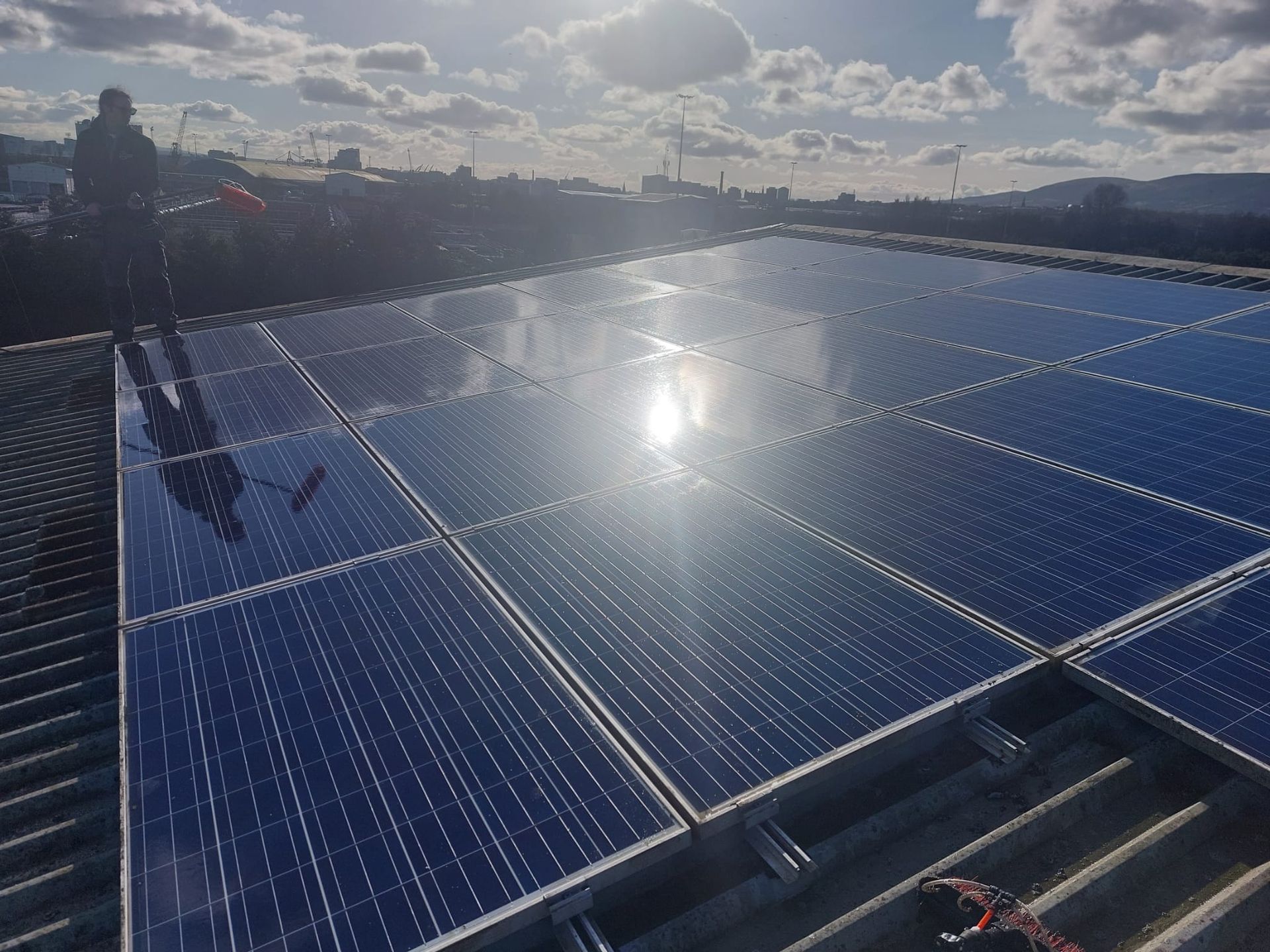 The sun is shining through the solar panels on the roof