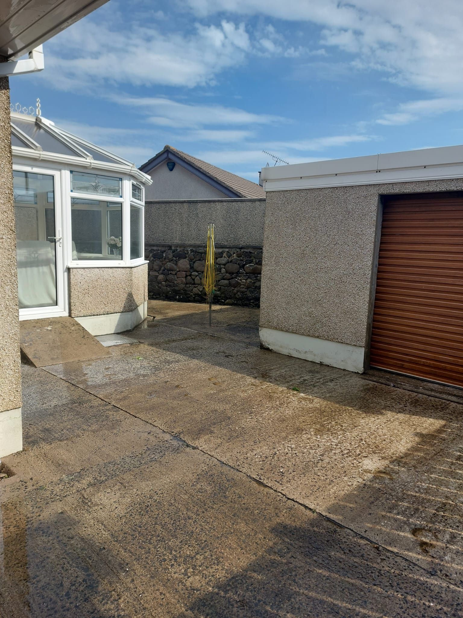 There is a garage in the backyard of a house.