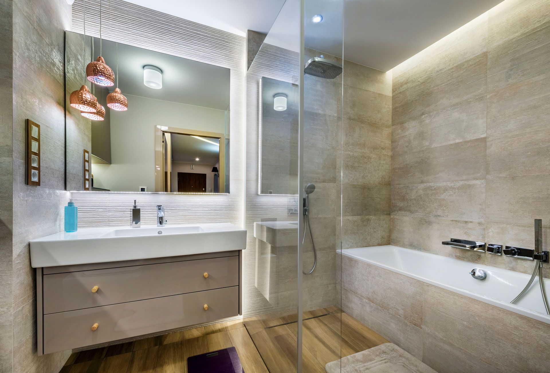 A bathroom with a bathtub , sink , mirror and walk in shower .