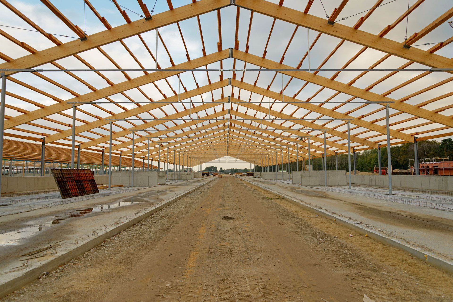 A large building under construction with a wooden roof